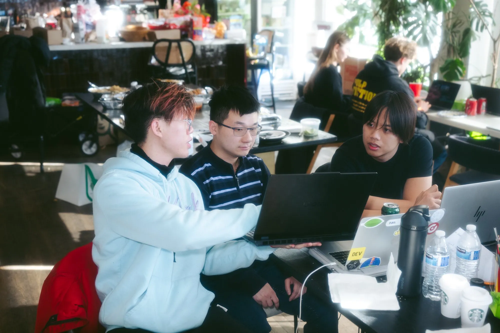 Team huddling around laptop