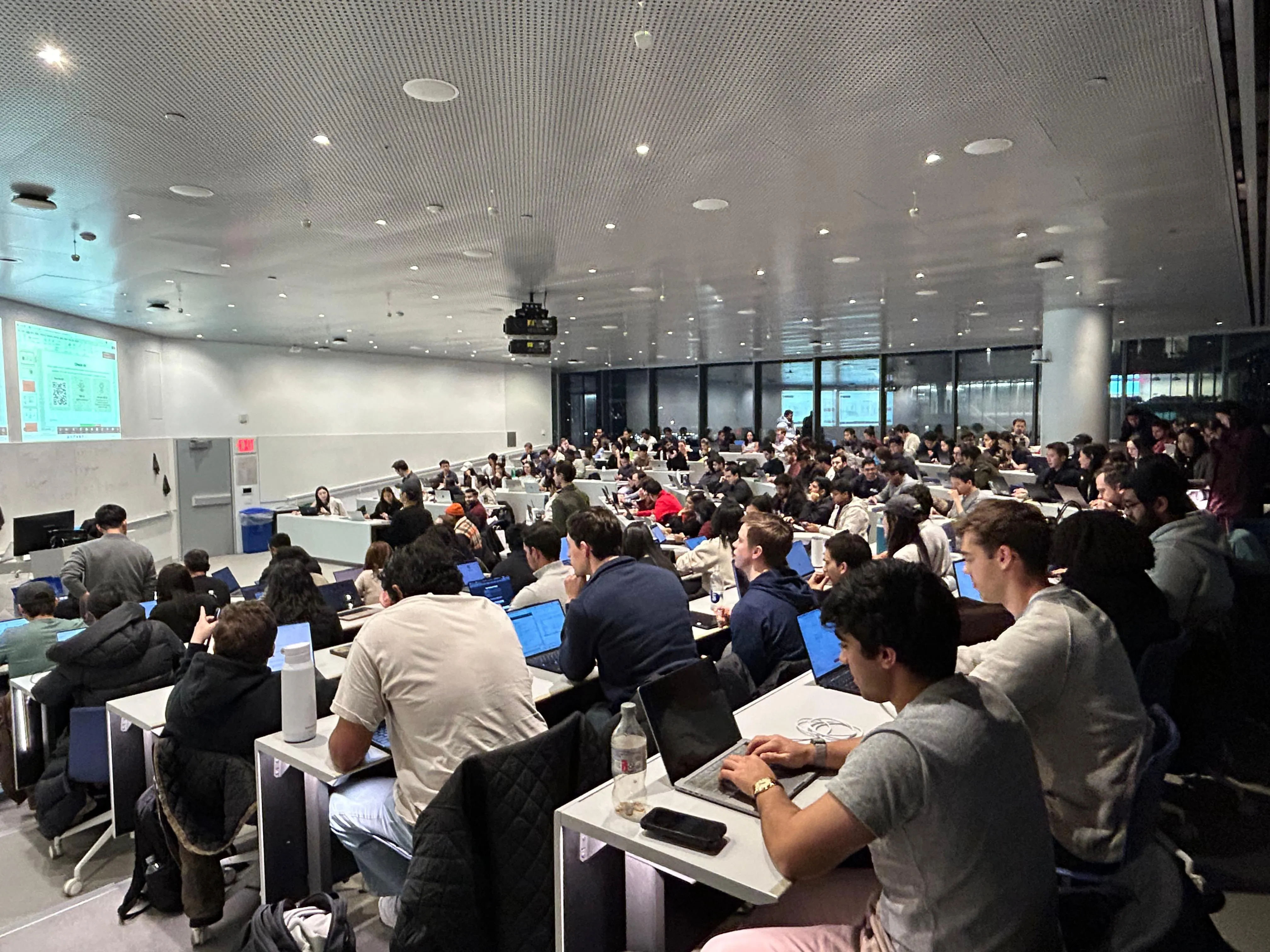 A packed lecture hall of students on laptops at the Claude community event